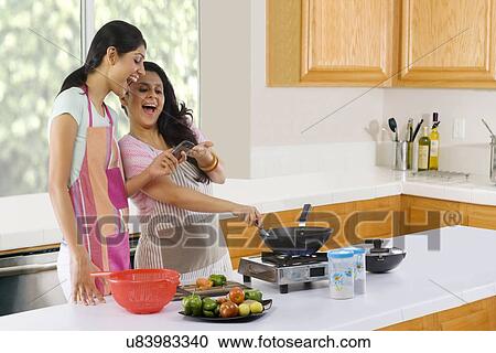 Mother and daughter cooking in the kitchen View Large Photo Image Stock Image - Mother and daughter cooking in the kitchen . Fotosearch