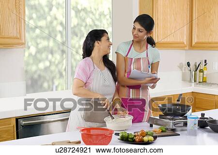 Mother and daughter in the kitchen View Large Photo Image Stock Image - Mother and daughter in the kitchen . Fotosearch