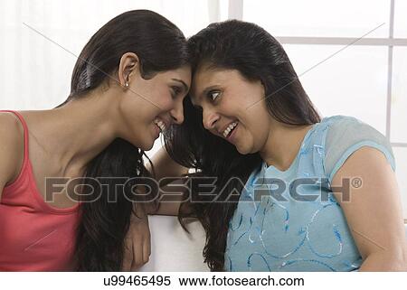 Stock Photography - Mother and daughter looking eye to eye . Fotosearch