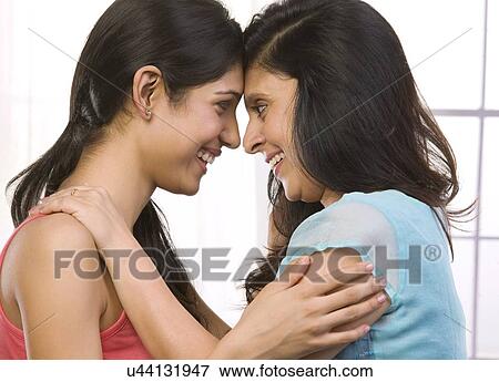 Stock Photo - Mother and daughter looking face to face . Fotosearch