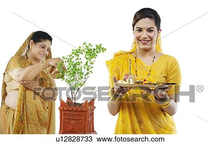 Mother and daughter making an offering View Large Photo Image Stock Image - Mother and daughter making an offering . Fotosearch