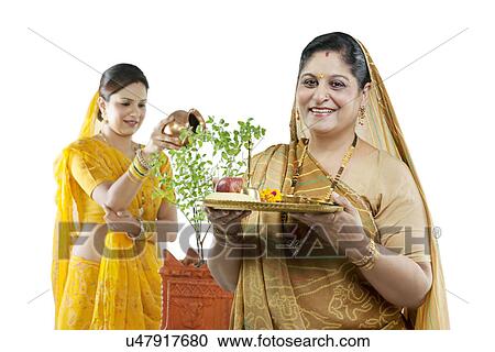 Mother and daughter making an offering View Large Photo Image Stock Image - Mother and daughter making an offering . Fotosearch