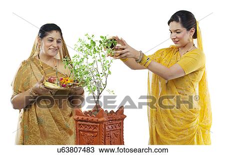 Mother and daughter making an offering View Large Photo Image Stock Image - Mother and daughter making an offering . Fotosearch