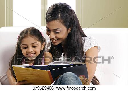 Mother and daughter reading a story book View Large Photo Image Stock Photograph - Mother and daughter reading a story book . Fotosearch