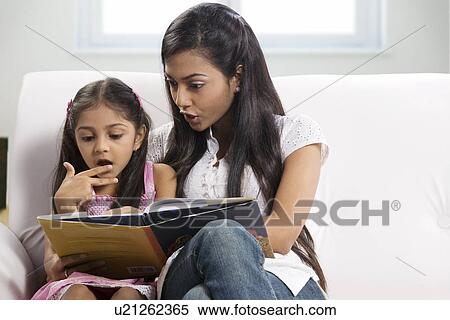 Mother and daughter reading a story book View Large Photo Image Stock Photography - Mother and daughter reading a story book . Fotosearch