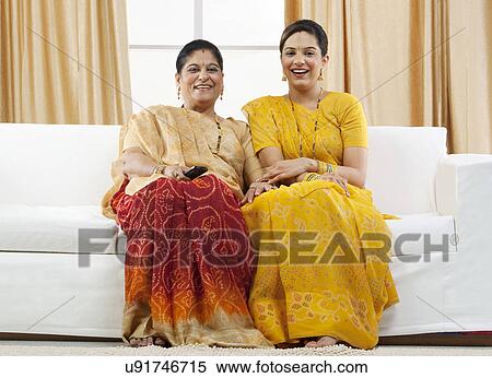 Stock Photography - Mother and daughter watching television . Fotosearch
