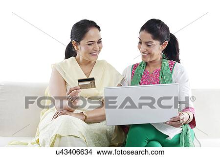 Mother and daughter with a laptop and credit card View Large Photo Image Picture - Mother and daughter with a laptop and credit card . Fotosearch