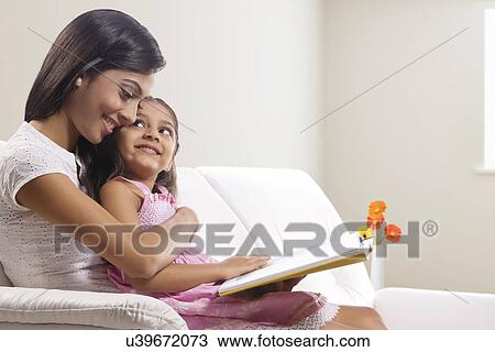 Mother and daughter with a story book View Large Photo Image Stock Image - Mother and daughter with a story book . Fotosearch