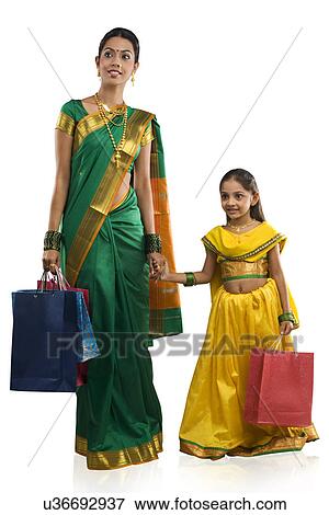 Stock Photo - Mother and daughter with shopping bags . Fotosearch