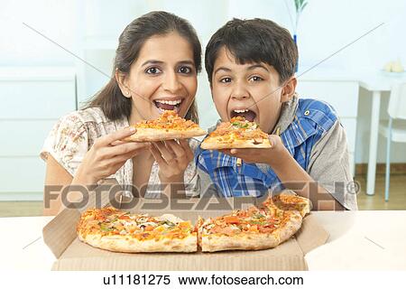 Mother and son eating pizza View Large Photo Image Stock Photography - Mother and son eating pizza . Fotosearch