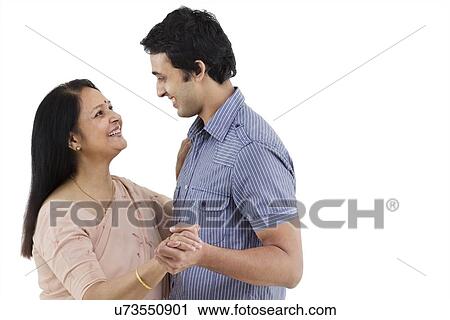 Stock Image - Mother and son looking at each other while dancing . Fotosearch