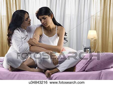 Mother consoling her daughter View Large Photo Image Stock Photograph - Mother consoling her daughter . Fotosearch