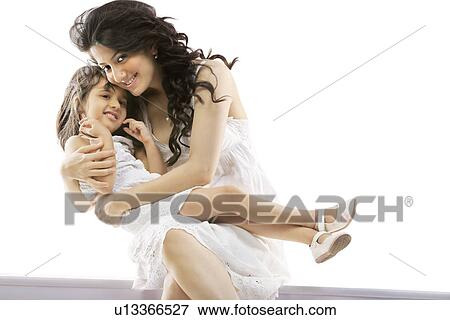 Mother holding her daughter View Large Photo Image Stock Photo - Mother holding her daughter . Fotosearch