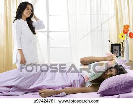 Mother waking her daughter up in the morning View Large Photo Image Stock Image - Mother waking her daughter up in the morning . Fotosearch