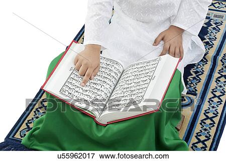 Muslim boy reading the Quran View Large Photo Image Stock Photo - Muslim boy reading the Quran . Fotosearch