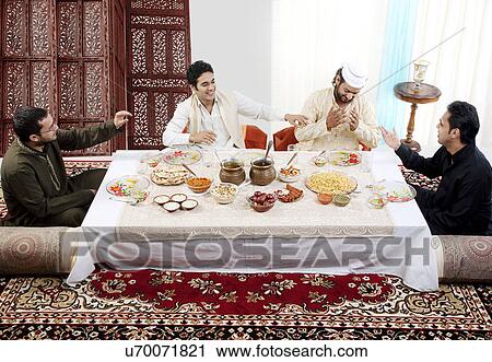 Muslim men enjoying themselves during Id View Large Photo Image Stock Image - Muslim men enjoying themselves during Id . Fotosearch