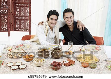 Stock Photo - Muslim men enjoying themselves during Id . Fotosearch