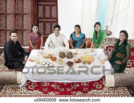 Stock Photo - Muslim people having food during Id . Fotosearch
