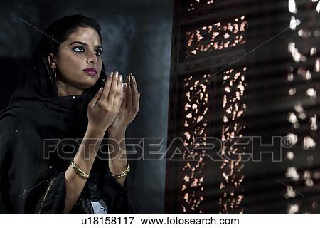 Stock Photo - Muslim woman doing Namaaz . Fotosearch