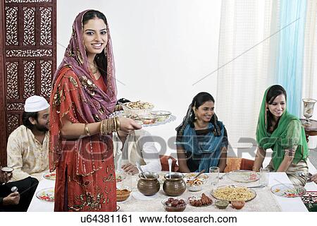 Muslim woman serving food during Id View Large Photo Image Stock Image - Muslim woman serving food during Id . Fotosearch