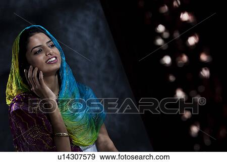 Muslim woman talking on the phone View Large Photo Image Stock Photo - Muslim woman talking on the phone . Fotosearch