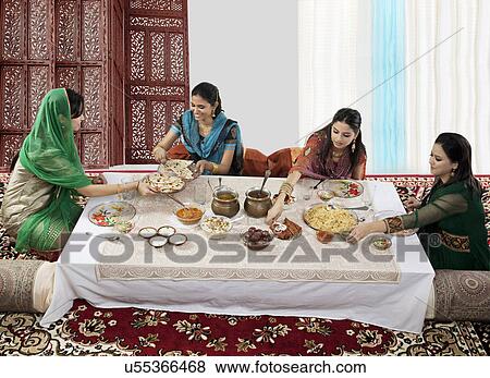 Stock Photo - Muslim women having food during Id . Fotosearch