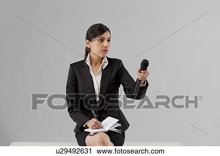 News reporter asking comment while writing in notepad against colored background View Large Photo Image Stock Image - News reporter asking comment while writing in notepad against colored background . Fotosearch