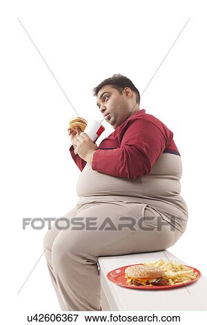 Obese man eating junk food View Large Photo Image Stock Photo - Obese man eating junk food . Fotosearch
