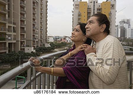 Old couple standing on a balcony View Large Photo Image Picture - Old couple standing on a balcony . Fotosearch