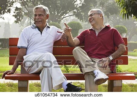 Picture - Old man pointing something out to his friend . Fotosearch