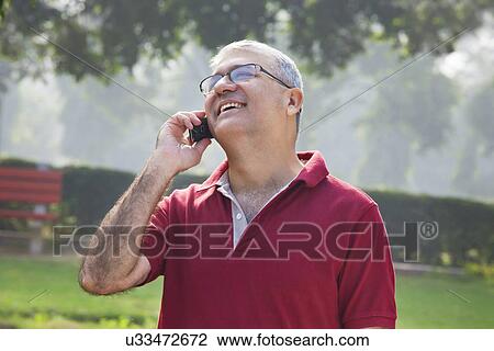 Old man talking on a mobile phone View Large Photo Image Stock Image - Old man talking on a mobile phone . Fotosearch