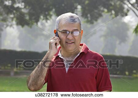 Old man talking on a mobile phone View Large Photo Image Stock Photo - Old man talking on a mobile phone . Fotosearch