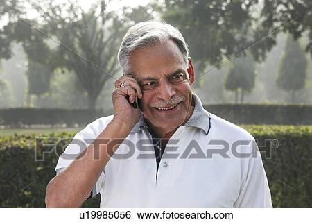Old man talking on a mobile phone View Large Photo Image Stock Photograph - Old man talking on a mobile phone . Fotosearch