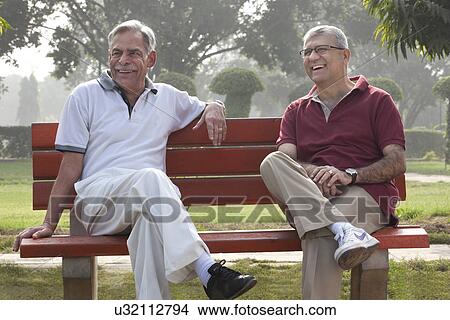 Picture - Old men sitting on a bench in a park smiling . Fotosearch