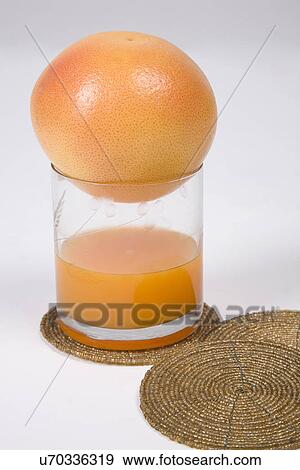 Orange placed on a glass View Large Photo Image Stock Photo - Orange placed on a glass . Fotosearch