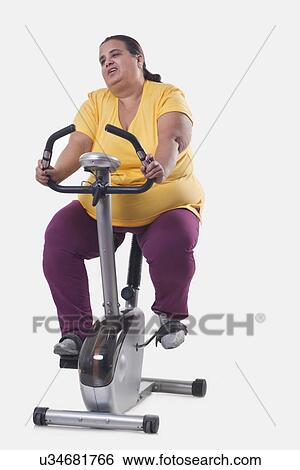 Overweight woman trying losing weight over white background View Large Photo Image Stock Photograph - Overweight woman trying losing weight over white background . Fotosearch