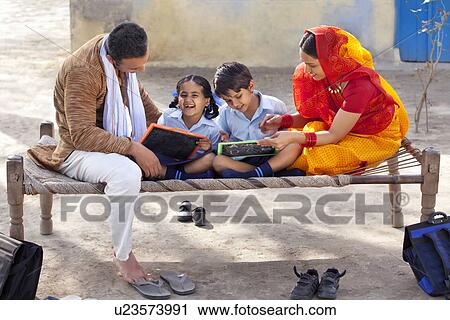 Stock Image - Parents assisting children with their homework . Fotosearch