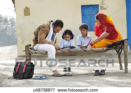 Parents helping children with their homework View Large Photo Image Stock Photo - Parents helping children with their homework . Fotosearch