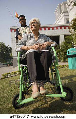 Stock Photo - Patient accompanied by attendant . Fotosearch