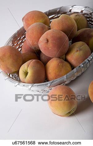 Stock Photo - Peaches in a basket . Fotosearch