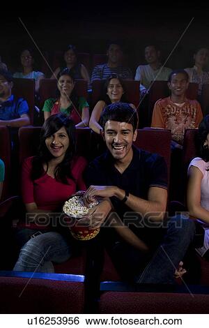 People watching a movie View Large Photo Image Stock Photograph - People watching a movie . Fotosearch