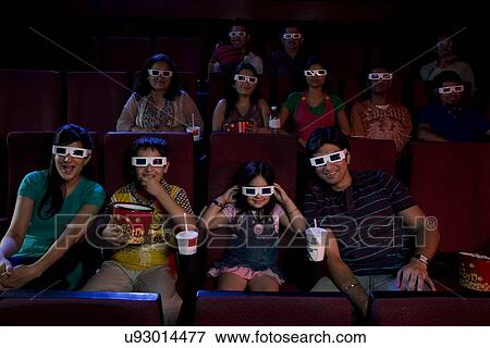 Stock Photo - People watching a movie with 3D glasses . Fotosearch