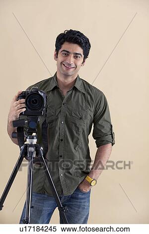 Photographer with camera on the tripod View Large Photo Image Stock Photography - Photographer with camera on the tripod . Fotosearch