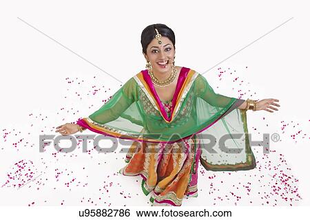 Stock Photograph - Portrait of a beautiful bride showered with rose petals. Fotosearch