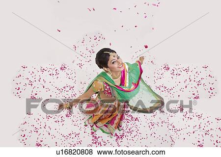 Stock Photo - Portrait of a beautiful bride surrounded by rose petals. Fotosearch