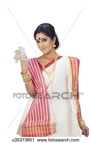 Stock Image - Portrait of a Bengali woman holding currency notes. Fotosearch
