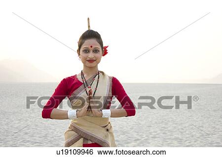 Stock Photograph - Portrait of a Bihu dancer greeting . Fotosearch