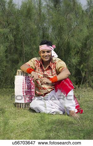 Portrait of a Bihu dancer sitting with a dhol View Large Photo Image Stock Photo - Portrait of a Bihu dancer sitting with a dhol . Fotosearch