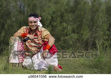 Portrait of a Bihu dancer sitting with a dhol View Large Photo Image Stock Photograph - Portrait of a Bihu dancer sitting with a dhol . Fotosearch