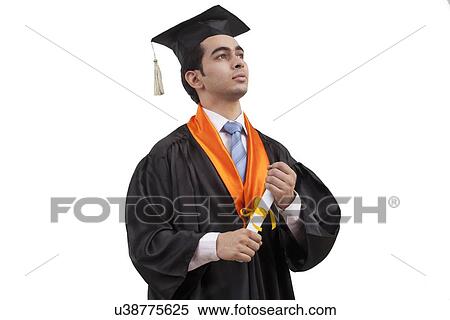 Stock Photography - Portrait of a boy at graduation ceremony. Fotosearch